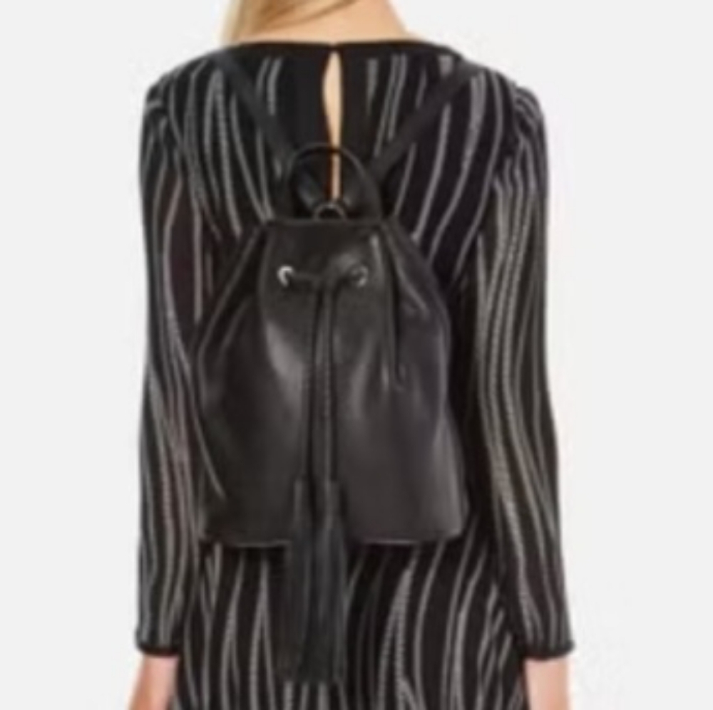 Rebecca Minkoff Isobel Tassel Backpack in Black Pebbled Leather.